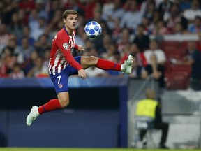 Atletico forward Antoine Griezmann, jumps for the ball during a Group A Champions League soccer match between Atletico Madrid and Club Brugge at the Wanda Metropolitano stadium in Madrid, Spain, Wednesday Oct. 3, 2018.