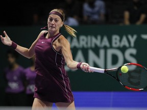 Petra Kvitova of the Czech Republic returns a shot from Ukraine's Elina Svitolina during their match at the WTA tennis finals in Singapore, Sunday, Oct. 21, 2018.