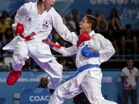 In this photo provided by the OIS/IOC, Masaki Yamaoka of Japan and Pedropablo De La Roca Lopez of Guatemala compete in the Elimination Round Pool B match in the Karate Men's -61kg, at the Europa Pavilion during the Youth Olympic Summer Games in Buenos Aires, Argentina, Wednesday, Oct. 17, 2018