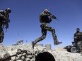 Afghan commandos in Pandola village near the site of a U.S. bombing in the Achin district of Jalalabad, east of Kabul, Afghanistan, Friday, April 14, 2017.