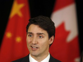 Prime Minister Justin Trudeau speaks to the media at a hotel in Beijing, China, Tuesday, Dec. 5, 2017.