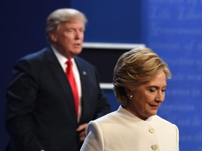 This file photo taken on October 19, 2016 shows  former Democratic nominee Hillary Clinton (R) and former Republican nominee Donald Trump walking off the stage after the final presidential debate at the Thomas Mack Center on the campus of the University of Las Vegas in Las Vegas, Nevada.