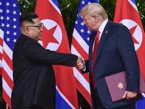 In this June 12, 2018 file photo, North Korea leader Kim Jong Un and U.S. President Donald Trump shake hands at the conclusion of their meetings at the Capella resort on Sentosa Island in Singapore.
