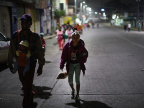 Hundreds of members of the Central American migrant caravan move in the early hours toward their next destination on November 04, 2018 in Isla, Mexico.