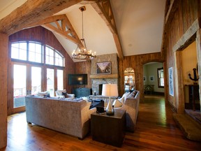 The stone fireplace and beam framework add warmth to the living room.