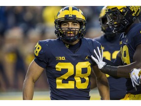 Michigan defensive back Brandon Watson (28) celebrates with defensive lineman Kwity Paye, right, after returning an interception for a touchdown in the third quarter of an NCAA college football game against Penn State in Ann Arbor, Mich., Saturday, Nov. 3, 2018. Michigan won 42-7.