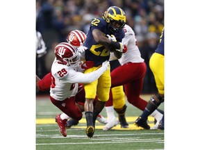 Michigan running back Karan Higdon (22) runs as Indiana defensive back Khalil Bryant (29) makes the tackle in the first half of an NCAA college football game in Ann Arbor, Mich., Saturday, Nov. 17, 2018.