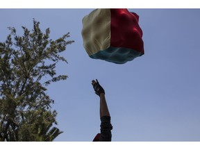 A Central American migrant plays with other colleagues with a bucket of fabrics at the Jesus Martinez stadium in Mexico City, Wednesday, Nov. 7, 2018. Central American migrants on Wednesday continued to straggle in for a rest stop at a Mexico City stadium, where about 4,500 continue to weigh offers to stay in Mexico against the desire of many to reach the U.S. border.