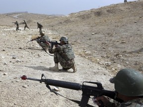 In this Oct. 31, 2018 photo, Afghan National Army soldiers carry out a training exercise at the Afghan Military Academy in Kabul, Afghanistan.