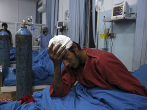 An injured man receives treatment at a hospital after a suicide bombing in Kabul, Afghanistan, Nov. 20, 2018.