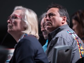 Assembly of First Nations National Chief Perry Bellegarde, right, and Minister of Crown-Indigenous Relations Carolyn Bennett listen while sitting together at the AFN annual general assembly, in Vancouver on Thursday, July 26, 2018.