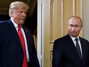 In this file photo taken on July 16, 2018 U.S. President Donald Trump (L) and Russian President Vladimir Putin arrive for a meeting in Helsinki.