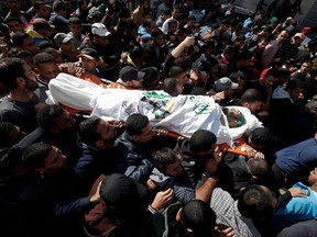 Mourners carry the body of Nour Baraka, a commander in the Islamist movement Hamas' military wing Al-Qassam Brigades and one of the seven Palestinians killed during an Israeli special forces operation in the Gaza Strip on November 12, 2018 in Khan Younis.
