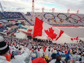 Fans cheer as the Canadian delegation makes its entrance during the opening ceremony of the Winter Olympic Games in Calgary on Feb. 13, 1988.
