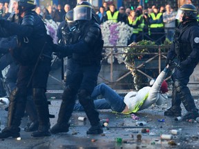 A policeman evacuates a demonstrator in Quimper, western France, during a nationwide day of protest.