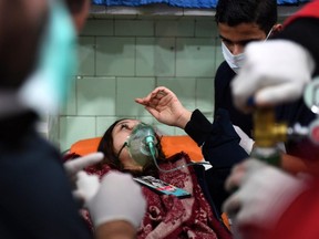 A Syrian woman receives treatment at a hospital in regime-controlled Aleppo on November 24, 2018.