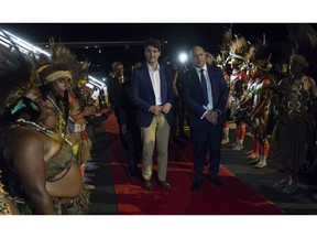 Canadian Prime Minister Justin Trudeau is greeted by Charles Abel, Deputy Prime Minister and Treasurer of Papua New Guinea as he arrives in Port Moresby, Papua New Guinea Friday November 16, 2018.