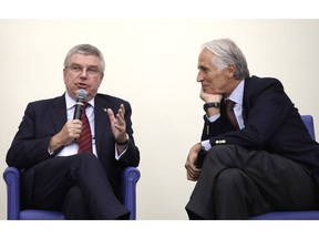 International Olympic Committee President Thomas Bach, left, and Italian Olympic Committee President Giovanni Malago', attend a press conference in Rome, Thursday, Nov. 8, 2018. Bach has given his blessing for Milan and Cortina d'Ampezzo's bid for the 2026 Winter Olympics to move forward without funding from the Italian government.