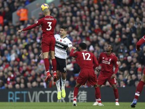 Liverpool's Fabinho, left,  wins a header against Fulham's Aleksandar Mitrovic, during the English Premier League soccer match between Liverpool and Fulham, at Anfield Stadium, in Liverpool, England, Sunday, Nov. 11, 2018.