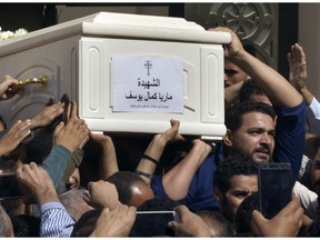 Relatives and friends carry the coffin of, Maria Kamal, after funeral service at the Church of Great Martyr Prince Tadros, in Minya, Egypt, Saturday, Nov. 3, 2018. Coptic Christians in the Egyptian town of Minya prepared to bury their dead, a day after militants ambushed three buses carrying Christian pilgrims on their way to a remote desert monastery, killing several and wounding others.