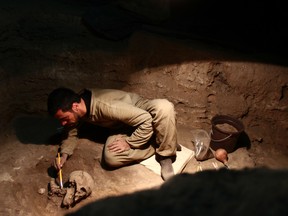 A photo provided by André Strauss shows the excavation of a skeleton approximately 9,600 years old in a rock shelter in Brazil.