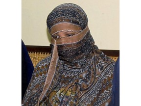 FILE - In this Nov. 20, 2010, file photo, Asia Bibi, a Pakistani Christian woman, listens to officials at a prison in Sheikhupura near Lahore, Pakistan. Italy is working to help relocate the family of a Pakistani Christian woman acquitted eight years after being sentenced to death for blasphemy, amid warnings from her husband that their life is in danger in Pakistan.  (AP Photo, File)