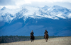 Prime Minister Justin Trudeau, left, and Chief Joe Alphone of Anaham and several other Chiefs of the Tsilhqot’in National Government ride horseback near Chilko Lake, B.C., Nov. 2, 2018.