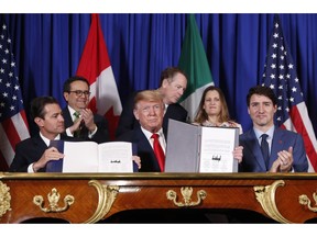 President Donald Trump, Canada's Prime Minister Justin Trudeau, right,  and Mexico's President Enrique Pena Neto, left, participate in the USMCA signing ceremony, Friday, Nov. 30, 2018 in Buenos Aires, Argentina.