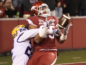 LSU defender Kristian Fulton (22) breaks up a pass intended for Arkansas tight end Cheyenne O'Grady during the first half of an NCAA college football game, Saturday, Nov. 10, 2018, in Fayetteville, Ark.