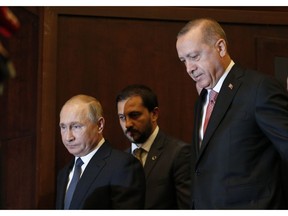 Russian President Vladimir Putin, left, and Turkey's President Recep Tayyip Erdogan, right, arrive to an event marking the completion of one of the phases of the Turkish Stream natural gas pipeline, in Istanbul, Monday, Nov. 19, 2018.