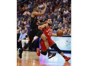 Toronto Raptors guard Fred VanVleet (23) drives past Phoenix Suns forward Mikal Bridges (25) during the first half of an NBA basketball game, Friday, Nov. 2, 2018, in Phoenix.