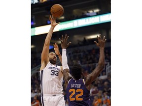 Memphis Grizzlies center Marc Gasol (33) shoots over Phoenix Suns center Deandre Ayton in the first half during an NBA basketball game, Sunday, Nov. 4, 2018, in Phoenix.