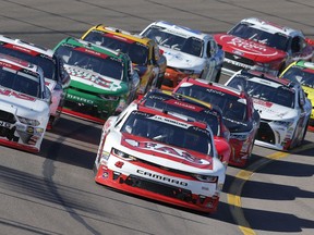 John H. Nemecheck (42) leads the field at the green flag lap during the NASCAR Xfinity Series auto race on Saturday, Nov. 10, 2018, in Avondale, Ariz.