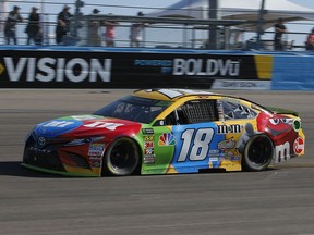 Kyle Busch (18) races on lap 210 during a NASCAR Cup Series auto race on Sunday, Nov. 11, 2018, in Avondale, Ariz.