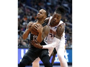 Brooklyn Nets guard Shabazz Napier (13) gets pressured by Phoenix Suns forward Richaun Holmes during the first half of an NBA basketball game Tuesday, Nov. 6, 2018, in Phoenix.
