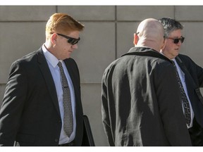 File - In a Wednesday, March 21, 2018 file photo, Border Patrol agent Lonnie Swartz, left, makes his way to the U.S. District Court building in downtown Tucson, Ariz. A jury in Arizona has acquitted a U.S. Border Patrol agent of manslaughter in the cross-border shooting death of a Mexican teen six years ago. Jurors found Swartz not guilty of involuntary manslaughter Wednesday, Nov. 21, 2018. It was his second trial after another jury acquitted him of second-degree murder and deadlocked on the manslaughter charge earlier this year.