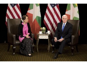 U.S. Vice President Mike Pence, right, meets Myanmar leader Aung San Suu Kyi in Singapore, Wednesday, Nov. 14, 2018. Pence is Singapore to attend the 33rd ASEAN summit.