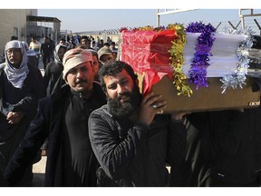 Mourners carry a coffin of prominent social activist Wissam al-Ghrawi in Basra, Iraq, Sunday, Nov. 18, 2018. Iraqi police say religious cleric Wissam, who was linked to the ongoing protests over poor services in Basra, was killed outside his home after suggested that demonstrators should take up arms over the conditions in the city.