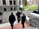 B.C. legislature Sergeant-at-Arms Gary Lenz, centre, is escorted out of the legislature by security, in Victoria on Nov. 20, 2018.