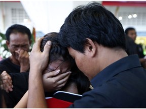 In this Thursday, Nov. 15, 2018, photo, relatives of 13-year-old Thai kickboxer Anucha Tasako cry during his funeral services at a Buddhist temple in Samut Prakan province, Thailand. Anucha died of a brain hemorrhage two days after he was knocked out in a bout on Nov. 10 that was his 174th match in the career he started at age 8. Thai lawmakers recently suggested barring children younger than 12 from competitive boxing, but boxing enthusiasts strongly oppose the change.