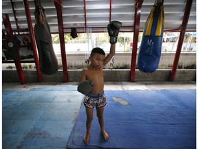 In this Wednesday, Nov. 14, 2018, photo, Thai kickboxer Chaichana Saengngern, 10-years old, warms up at a training camp in Bangkok, Thailand. Thai lawmakers recently suggested barring children younger than 12 from competitive boxing, but boxing enthusiasts strongly oppose the change. They say the sport is part of Thai culture and gives poor families the opportunity to raise a champion that will lift their economic circumstances.