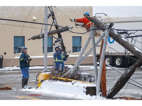 Electric company crews repair downed power poles, a transformer and lines on Eden Street in Charlottetown Thursday November 29, 2018 as a power storm hits Prince Edward Island. Winds gusting to 100 km/h along with snow and rain has knocked power out to more than 40,000 Maritime Electric customers as of mid-afternoon. High tides and surf is causing damage along the north shore of the province.