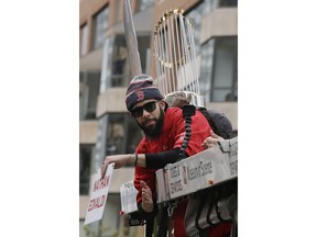 Boston Red Sox's David Price rides with the trophy during a parade to celebrate the team's World Series championship over the Los Angeles Dodgers, Wednesday, Oct. 31, 2018, in Boston.