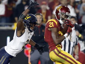 Southern California wide receiver Tyler Vaughns, right, cradles a touchdown catch with California cornerback Elijah Hicks defending during the first half of an NCAA college football game in Los Angeles, Saturday, Nov. 10, 2018.