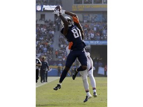 Los Angeles Chargers wide receiver Mike Williams catches a pass over Denver Broncos defensive back Tramaine Brock. during the first half of an NFL football game Sunday, Nov. 18, 2018, in Carson, Calif.