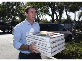 Rep. Duncan Hunter, R-Calif.,brings pizza to campaign workers on Tuesday Nov. 6, 2018, in Santee, Calif. Hunter faces Democratic candidate Ammar Campa-Najjar in the race for Southern California's 50th district.