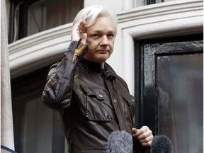 FILE - In this May 19, 2017, file photo, WikiLeaks founder Julian Assange greets supporters from a balcony of the Ecuadorian embassy in London. The Justice Department inadvertently named Assange in a court filing in an unrelated case that raised immediate questions about whether the WikiLeaks founder had been charged under seal. Assange's name appears twice in an August 2018 filing from a prosecutor in Virginia in a separate case involving a man accused of coercing a minor.