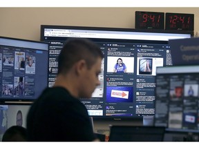 FILE - In this Oct. 17, 2018 file photo, a man works at his desk in front of monitors during a demonstration in the war room, where Facebook monitors election related content on the platform, in Menlo Park, Calif. Facebook and other social platforms have been waging a fight against online misinformation and hate speech for two years. With the U.S. midterm elections coming soon on Tuesday, Nov. 6, there are signs that they're making some headway, although they're still a long way from winning the war.