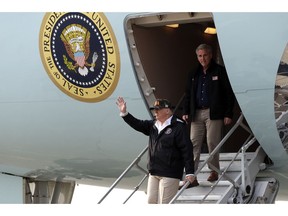 President Donald Trump waves as he arrives on Air Force One at Beale Air Force Base for a visit to areas impacted by the wildfires, Saturday, Nov. 17, 2018, at Beale Air Force Base, Calif.  He is followed by House Majority Leader Kevin McCarthy of Calif.