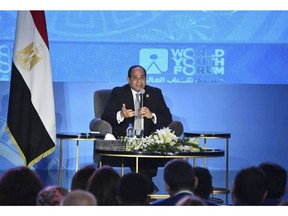 In this photo provided by Egypt's state news agency MENA, Egyptian President Abdel-Fattah el-Sissi, speaks during a youth conference in Sharm El Sheikh, Egypt, Monday, Nov. 5, 2018. Addressing the international youth conference late Sunday el-Sissi said that the 2011 Arab Spring revolt was an ill-advised attempt at change whose chaotic aftermath posed an existential threat to the nation. Egypt's president said those behind the revolt had good intentions but had inadvertently "opened the gates of hell." (MENA via AP)